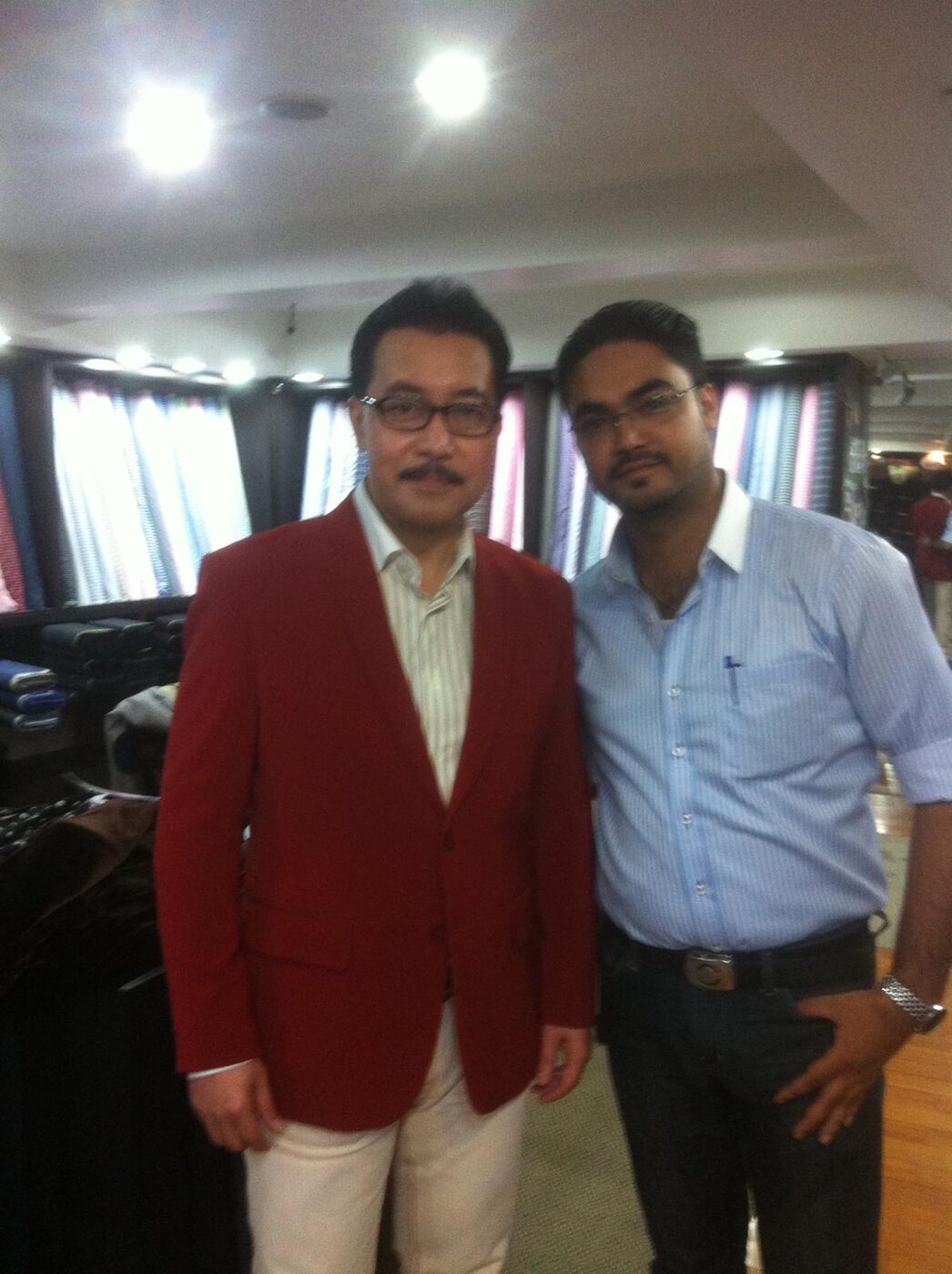 A client with the tailor inside the shop