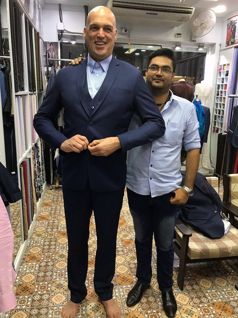 A client being fitted for a three-piece suit inside the atelier