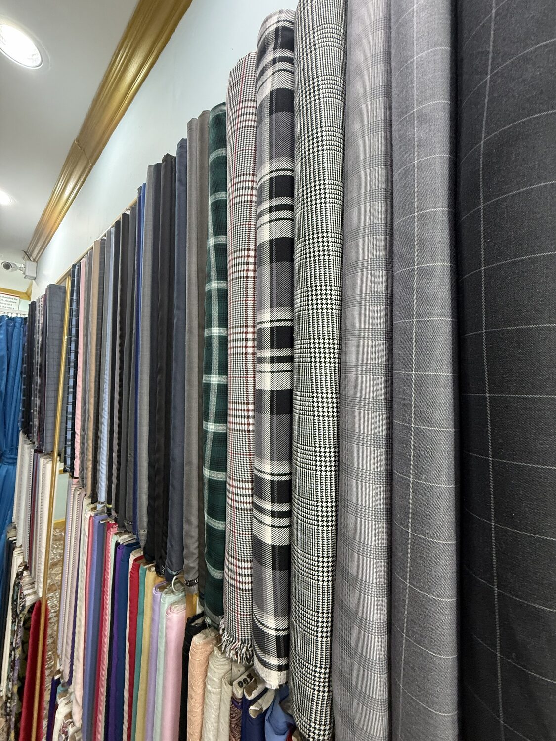 The cloth wall — bolts of checked, windowpane and houndstooth suiting